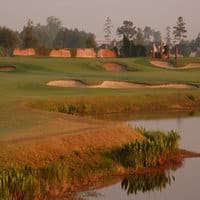 Golf course at sunset with bunkers and water