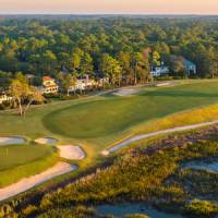 Aerial view of coastal golf course and houses