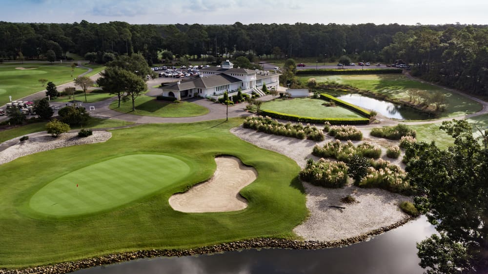 Aerial golf course with clubhouse and pond