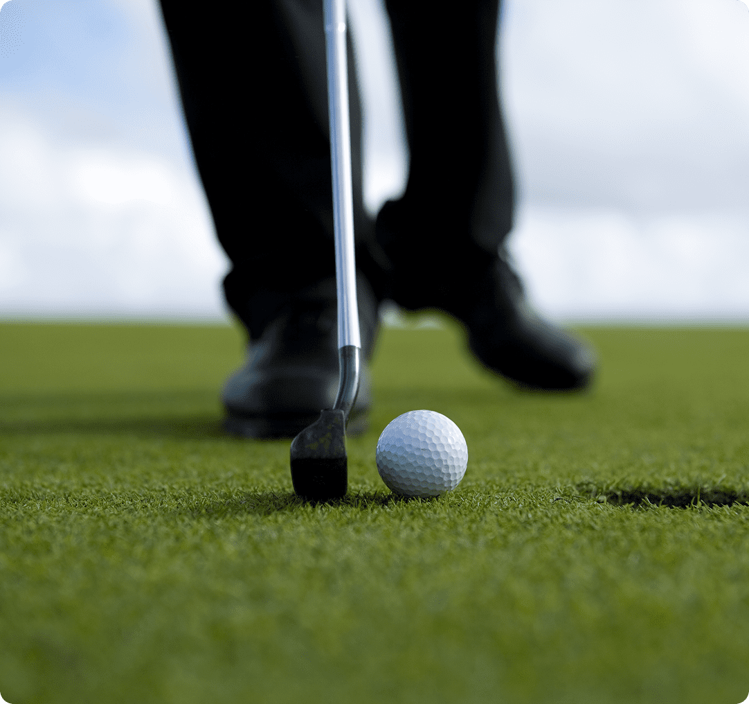 Close-up of golf ball and club