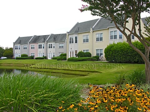 Colorful row houses near landscaped garden