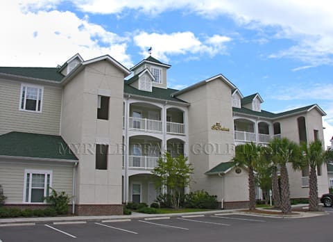 White and green multi-unit housing structure