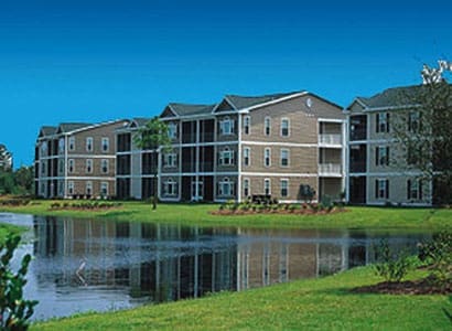 Apartment buildings by a serene lake